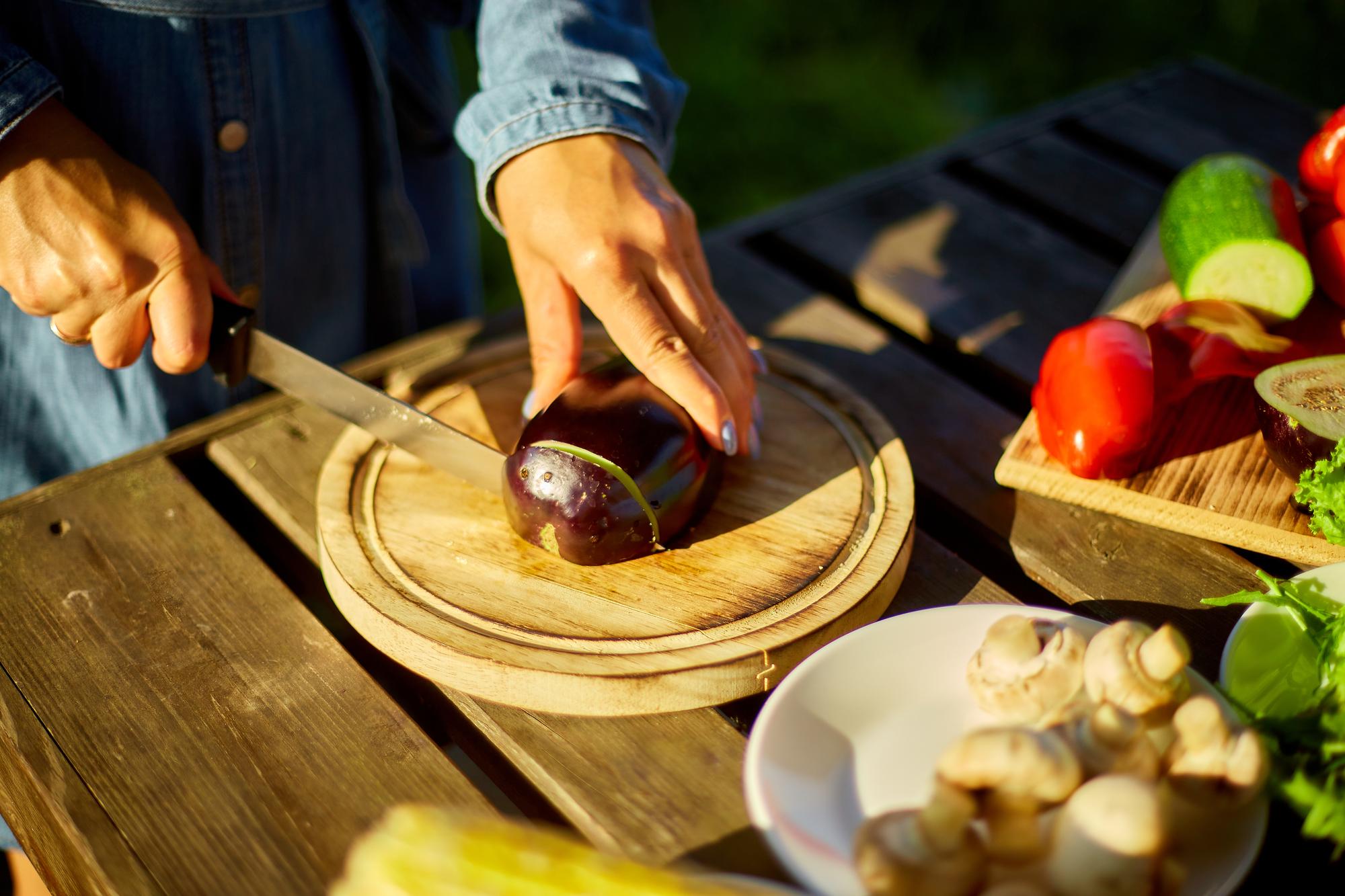 Chef arranging plated seasonal dish on wooden table